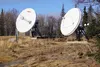 Dry grass and bare ground surrounds two satellite dishes on March 6, 2025, at the National Weather Service office in Anchorage.  Yereth Rosen/Alaska Beacon