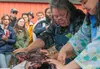 Amy Hedlund Rogde, Soldotna, AK, and 2024 ASF Cultural Ambassador Lisa Lynch demonstrate skinning a seal at The Gathering Place Sunday afternoon at the 2024 Alaska State Fair. (DSC_8621)(9-1-