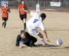 Palmer senior Brandon Wisner falls over Houston goalkeeper Jake Davis during Palmer's 8-0 win over Houston on Tuesday. JEREMIAH BARTZ/Frontiersman