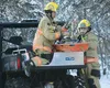 Emergency Responders secure cargo to the back of an all-terrain vehicle  before responding to a mid-air collision between two planes in the woods near the South Hollywood landing strip Jan. 3