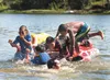 A group of kids battle for a spot on an inflatable water toy while swimming at the Finger Lake State Recreation Area Monday afternoon. ROBERT DeBERRY/Frontiersman.com
