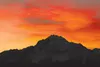 ROBERT DeBERRY/Frontiersman Pioneer Peak is silouhetted against
the orange and red of the sky as the sun begins to rise Thursday
morning.