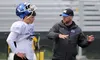 Milikin University offensive coordinator Mike Budziszewski, right, works with Palmer High senior quarterback Luke Guggenmos during the second day of the All-Alaska Football Camp Friday aftern