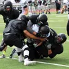 A gang of Colony Knights tackle a South Anhorage ball carrier during a scrimmage against the Wolverines Saturday, Aug. 6, 2016, at Eagle River High School. Matt Hickman/Frontiersman