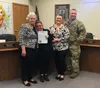 Palmer Mayor Edna DeVries poses for a photo with Rikki King and her parents Rene and Troy. DeVries gave the King family a proclamation declaring Oct. 23 Kabuki Syndrome Awareness day in Palme