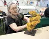 Christmas Friendship Dinner volunteer Viola Petty works on table
decorations in preparation for today event at the Curtis D. Menard
Memorial Sports Center in Wasilla. The friendship dinner is