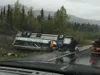 A 55-passenger bus owned by Princess Cruise lines rests on its roof after a roll-over wreck near Mile 173, Parks Highway before emergency responders arrived at the scene. The wreck killed one