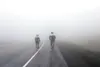 Palmer’s Kristin Wolf, left, and Erik Christensen cut through the fog as they climb Thompson Pass along the Richardson Highway during the Fireweed 400 earlier this month. Wolf won the race an