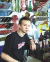 Matt Yoder sits behind the counter of Bandwagon Skate and
Snowboard Shop in Wasilla, where he says he has found his dream
job. Photo by EOWYN LeMAY IVEY/Frontiersman.