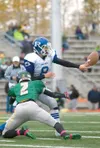 Palmer junior Jackson Buresh gets rid of the ball just as
Service High Cougar Kahlil Bolling makes contact during the first
quarter of Saturday play off game in Anchorage. (ROBERT
DeBERRY/Fro
