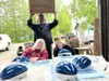 Kiwanians Patrick Garley (back), Carolyn Purser and Tonya Bruechet (left-right) preparing bike helmets for Colony Days distribution Courtesy photo