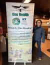 Louisa Branchflower, director of development at nonprofit Onward &amp; Upward in Palmer, poses with one of the organization’s promotional banners. Photo courtesy of Onward & Upward