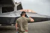 A U.S. Air Force crew chief assigned to the 154th Aircraft Maintenance Squadron salutes an F-22 Raptor pilot as he taxis onto the flightline at Kadena Air Base, Japan, June 6, 2022. Aircraft,