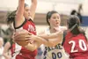 Ashley Swetzof drives between two Juneau-Douglas bears during
Thursday's game at Palmer High School. ROBERT
DeBERRY/Frontiersman