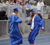 Larkin Christiansen and Camille Lambert had a routine as they walked in the procession to their seats during Palmer High's graduation ceremony Tuesday, May 14, 2024, at PHS. Jeremiah Bartz/Fr