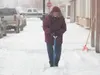 B&amp;B Bargins owner Anita Chase shovels snow from in front of
her store in downtown Palmer Thursday afternoon. ROBERT DeBERRY/Frontiersman
