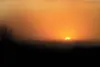 ROBERT DeBERRY/Frontiersman The windy conditions fill the air
with dust blurring the setting sun as it dips below the horizon
Thursday evening. The Matanuska-Susitna Borough has issued an air