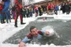 Mark Meyer, assistant manager of Lowe's, reaches for the ice
after plunging into ice-cold water at the Polar Plunge Saturday.
BOB MARTINSON/For the Frontiersman