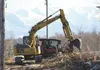 Crews with Quality Asphalt Paving clear brush along Lucus Road April 9 in preparation for work this summer that will add a turn lane to that road as part of a multi-phase Parks Highway upgrad