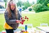 Evlyn Jackson arranges a bunch of flowers at the Palmer Museum Garden &amp; Art Faire. Katie Stark/For the Frontiersman