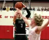 Colony's Sullivan Menard pulls up to shoot over the reach of Wasilla's Reilly Devine during a 59-49 win over the Warriors in the championship game of the Doc Larson Roundball Classic Saturday