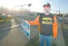 ROBERT DeBERRY/Frontiersman Houston resident Fred Nelius holds a
campaign sign at a gathering Friday afternoon at the corner of the
Parks Highway and Crusey Street in Wasilla. About 20 people