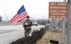 Wasilla's Dave Glenn stands near the Glenn Highway's SFC James Bondsteel Bridge of Honor across the Knik River on Tuesday, March 29, 2016. Glenn was standing honor guard to remember Bondsteel