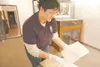 ROBERT DeBERRY/Frontiersman Wearing white gloves, Dorthy G. Page
Museum curator Bethany Buckingham gently handles a letter written
to C.L Cadwallader, president of the Commercial Club in Wasi