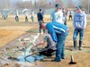 Members of the Palmer High School baseball team work to pump standing water from the right side of the infield of Palmer Senior Field. Local high school programs have been forced to cancel nu
