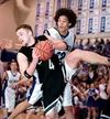 Colony's Joe Reza hauls down a rebound in front of Palmer's
Stanley Ratcliff during Colony's 60-47 win over the Moose at Palmer
High last Friday.WILLIAM WOODY/ Frontiersman
