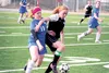 Colony captain Ali Baker, right, tries to get past Palmer’s Bekah Youngblood during a win over the Moose. JEREMIAH BARTZ/Frontiersman