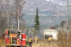 Firefighters work to extinguish a blaze that spread from a man's yard to his home and outbuildings Sunday on Spence Lane. HEATHER RESZ/Frontiersman