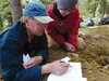 Tanana Chiefs Conference archaeologist Bob Sattler works with Palmer High School student Jenni Klebesadel during an Archaeology Field School trip to Deadman Lake earlier this month. The schoo