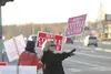 Bert Cottle for Wasilla Mayor supporters hold campaign signs and wave to passing traffic Tuesday evening along the Parks Highway in Wasilla. HEATHER A. RESZ/Frontiersman