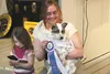 With daughter Cadence at her side, Brittany Maynard, holds her dog Mighty Mite, as he is named the winner of an online pet contest and the official mascot of Wasilla’s year-long centennial ce