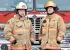 Assistant Fire Chief Jim Carnahan and son Kurtis stand in front of a West Lakes Fire Department truck at Station 71 on Pittman Road. The elder Carnahan is fighting for his life after being to