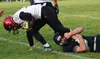 Houston quarterback Gavin Mulhaney attempts to shed the tackle of Nikiski’s Caileb Payne, Friday, Sept. 20, 2019, at Nikiski High School. Photo by Joey Klecka/Peninsula Clarion