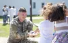 Spc. Joe Belles, a chemical, biological, radiological, and nuclear specialist for the 10th Chemical Company, 22nd Chemical Battalion, 48th Chemical Brigade, plays with Afghan evacuee children