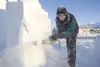 Jim Brown of the Winter Wizards Ice and Snow Carving Team works
the chainsaw on a block of snow at the Palmer Train Depot Thursday
afternoon in preparation for the Colony Christmas celebratio
