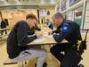 Jordan Cowsill signs an application with WPD officer Nate Lecours answering questions. Jacob Mann/Frontiersman