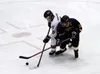 Houston freshman Blake Rogers battles Glennallen's Daks Bowman for the puck during a win over Glennallen at the Menard Arena last week. Smolden scored a combined four goals during two victori