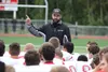 Will Stout, the first-year head coach of the Wasilla High football program, talks to his players following a scrimmage with Bartlett Friday, Aug. 6, 2016, at Veterans Memorial Field in Wasill