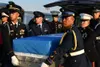 Members from the United Nations Command Honor Guard remove remains of a fallen service member from a vehicle and load it onto a waiting C-17 Globemaster III at Osan Air Base, South Korea, Aug