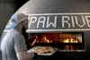 Bearpaw River Brewing Company pizza cook Joe Kays takes a pizza out of the oven Tim Rockey / Frontiersman