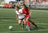 Colony freshman Madison Wakaliuk tries to move the ball away from Wasilla freshman Nicole Catlett during a 1-0 win over the Warriors in the Northern Lights Conference Championships girls' tit