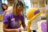 A “Magic Maker” from the Magic Yarn Project adds finishing touches to a Rapunzel wig at the Gold Workshop at Mat-Su Regional Medical Center. This gathering was designed for people to come and