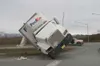 TODD L. DISHER/Frontiersman Three tow trucks use wire cables to
bring the truck back to its wheels