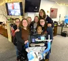 Eric Edwards, center, and his mother Judy, left, received a behind-the-scenes tour of MATCOM, a visit set up after they practiced calling 9-1-1 in case Eric, who uses assistive technology to 