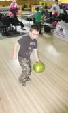 Lee Young, 7, gets a running start down the alley at North Bowl
during an Adoption Awareness Month event in Wasilla. Young and his
two siblings are adopted. (GREG JOHNSON/Frontiersman)