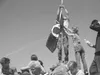 Patrick Wallace and Misty Flippo replace the POW/MIA flag at the
top of the mountain. Photo by ROBERT BARENZ/Colony High School.